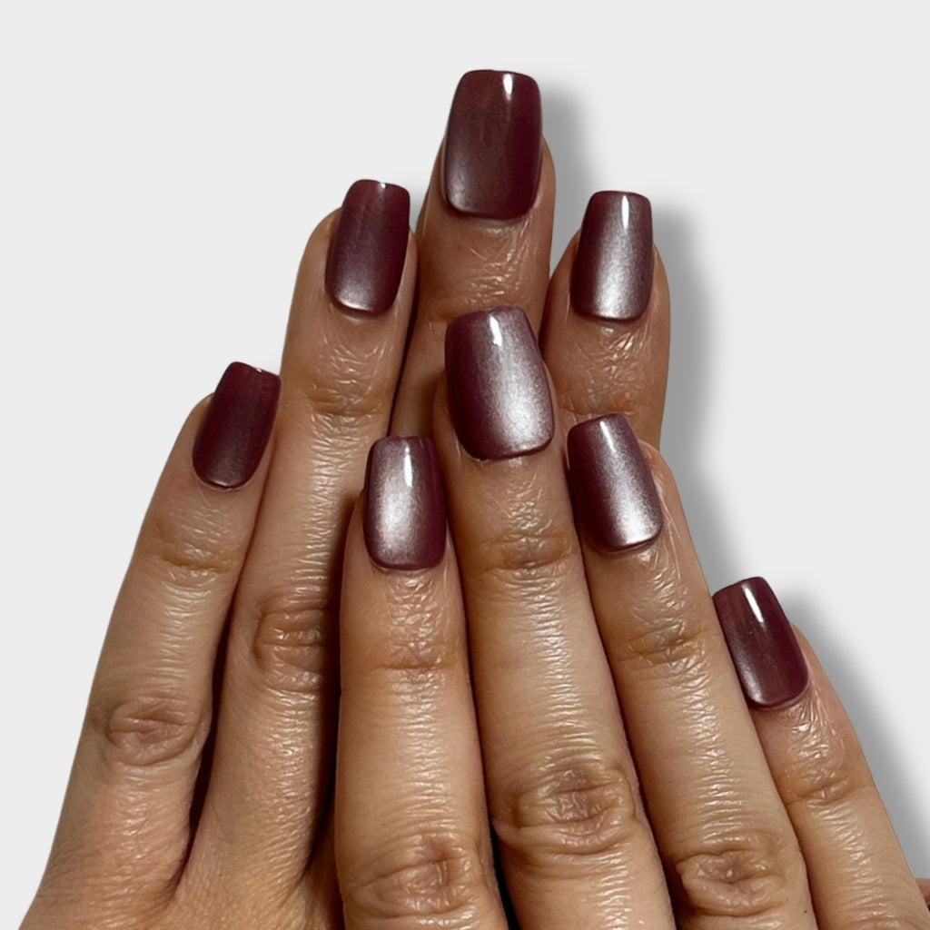 Cosmic Burgundy nail polish bottle from The Instant Nails, featuring a deep burgundy shade and sleek design.