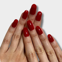 Iconic Red nail polish from The Instant Nails in a sleek bottle, showcasing its vibrant red color and glossy finish.