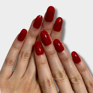 Iconic Red nail polish from The Instant Nails in a sleek bottle, showcasing its vibrant red color and glossy finish.