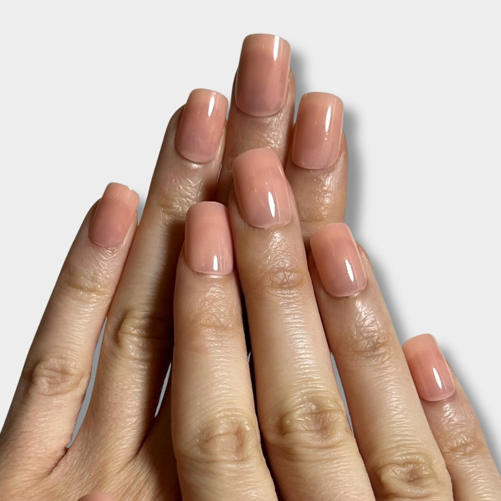 Peach skin fabric by The Instant Nails, showcasing a soft, smooth texture in a vibrant peach color.