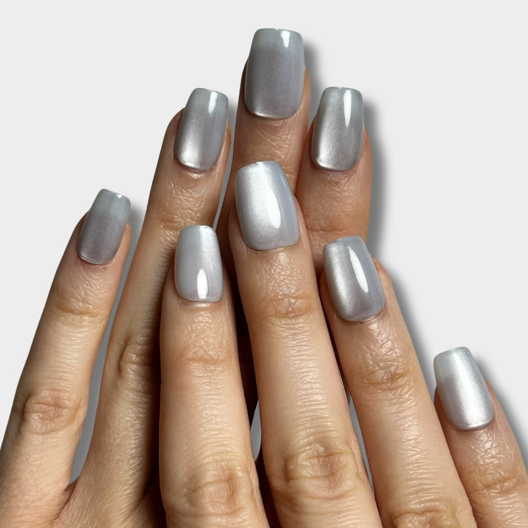 Pearl Grey nail polish by The Instant Nails in a sleek bottle, showcasing its elegant grey shade and glossy finish.