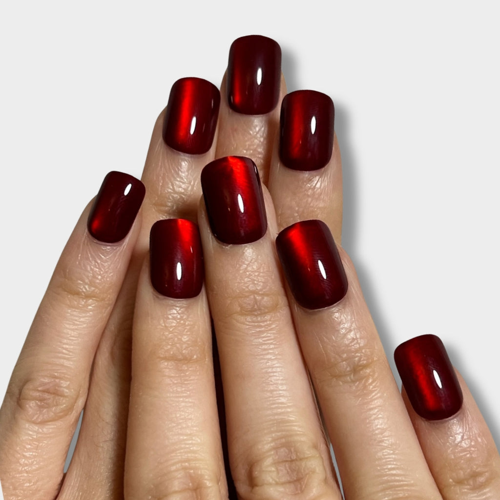 Ruby Spark nail polish by The Instant Nails showcased in a vibrant red bottle with a sleek design.