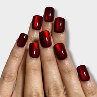 Ruby Spark nail polish by The Instant Nails showcased in a vibrant red bottle with a sleek design.